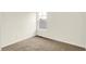 A neutral bedroom featuring tan carpet with a window at 3917 Wren Dr, Brownsburg, IN 46112