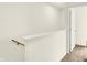 A well-lit hallway with a carpeted floor, wooden handrail, and white trim at 3917 Wren Dr, Brownsburg, IN 46112