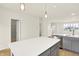 Modern kitchen featuring gray cabinets, stainless steel appliances, a kitchen island with white countertops, and light wood flooring at 3917 Wren Dr, Brownsburg, IN 46112