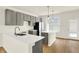 Bright kitchen with gray cabinets, stainless steel refrigerator, white countertops, and a kitchen island at 3917 Wren Dr, Brownsburg, IN 46112
