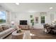 Cozy living space with hardwood floors, neutral tones, and dining area for modern living at 3917 Wren Dr, Brownsburg, IN 46112