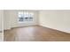 Bright, empty living room with hardwood floors, large windows, and neutral decor for a modern touch at 3917 Wren Dr, Brownsburg, IN 46112