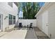 View of patio with chairs, small table, white fence, and a view of trees in the background at 3917 Wren Dr, Brownsburg, IN 46112