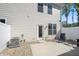 Back patio with chairs, view of exterior walls, access door, air conditioner, and newly installed concrete pad at 3917 Wren Dr, Brownsburg, IN 46112