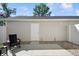 View of patio with chair, small table, exterior door, and white fence at 3917 Wren Dr, Brownsburg, IN 46112