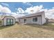 Backyard featuring a shed and a sliding glass door that leads to the patio, with a grassy area at 4313 Strawflower Dr, Indianapolis, IN 46203