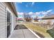 Backyard with a concrete patio and grassy area, bordered by a wooden fence, providing privacy at 4313 Strawflower Dr, Indianapolis, IN 46203