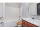 Bathroom with vanity, toilet and tub-shower combo with white tile and shower head for a clean, functional space at 4313 Strawflower Dr, Indianapolis, IN 46203