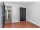Bedroom with hardwood floors and a closet; doorway leads to other rooms for convenient access at 4313 Strawflower Dr, Indianapolis, IN 46203