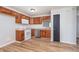 Cozy kitchen with wooden cabinets, white appliances, and vinyl flooring at 4313 Strawflower Dr, Indianapolis, IN 46203