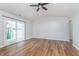 Bright living room with hardwood floors, sliding glass doors and ceiling fan for added comfort at 4313 Strawflower Dr, Indianapolis, IN 46203