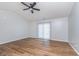 Spacious living room with hardwood floors and a ceiling fan, well lit with sliding glass doors at 4313 Strawflower Dr, Indianapolis, IN 46203