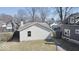 Backyard view of the house with vinyl siding, a sidewalk and green grass at 4619 Carrollton Ave, Indianapolis, IN 46205
