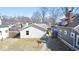 Backyard view of the house with vinyl siding, a sidewalk and green grass at 4619 Carrollton Ave, Indianapolis, IN 46205