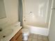 Bathroom featuring a tub and shower, sink with vanity, and toilet at 4619 Carrollton Ave, Indianapolis, IN 46205