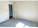 Bedroom with white walls, carpet flooring, and a white door at 4619 Carrollton Ave, Indianapolis, IN 46205