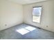 Bedroom with white walls, carpet flooring, a window letting in natural light at 4619 Carrollton Ave, Indianapolis, IN 46205