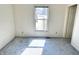 Bedroom with white walls, carpet flooring, a window letting in natural light, and a white door at 4619 Carrollton Ave, Indianapolis, IN 46205