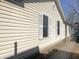View of home exterior with vinyl siding and white shutters on a sunny day at 4619 Carrollton Ave, Indianapolis, IN 46205