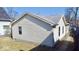 View of home exterior with vinyl siding and gray roof on a sunny day at 4619 Carrollton Ave, Indianapolis, IN 46205