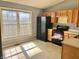Kitchen with black appliances, wooden cabinets, and a large window for plenty of sunlight at 4619 Carrollton Ave, Indianapolis, IN 46205
