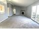 Spacious living room features a cozy fireplace, offering warmth and charm, with sliding doors to the outside at 4619 Carrollton Ave, Indianapolis, IN 46205