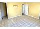 Living room with tile flooring, two entry doors, and electrical outlets ready for customization at 4619 Carrollton Ave, Indianapolis, IN 46205