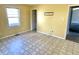 Open living area with tile flooring, electrical outlets, and multiple doorways at 4619 Carrollton Ave, Indianapolis, IN 46205