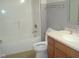 Clean bathroom featuring a white tub, modern fixtures, and a vanity with storage at 515 Bridgestone Dr, Mooresville, IN 46158