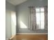Bright bedroom with wood floors, large windows, and stylish curtains at 515 Bridgestone Dr, Mooresville, IN 46158