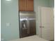 Modern kitchen features a stainless steel refrigerator and granite countertops at 515 Bridgestone Dr, Mooresville, IN 46158