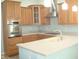 Well-lit kitchen features stainless steel appliances, light countertops, and wooden cabinets at 515 Bridgestone Dr, Mooresville, IN 46158