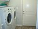 Convenient laundry room with a modern washer and dryer and a utility closet at 515 Bridgestone Dr, Mooresville, IN 46158