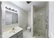 Bright bathroom featuring a glass-enclosed shower, a toilet, and a vanity with ample space at 5525 Roxbury Ter, Indianapolis, IN 46226