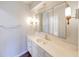 Bathroom featuring a white vanity with unique sink, bright lighting, and decorative mirrors at 5525 Roxbury Ter, Indianapolis, IN 46226