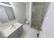Bright bathroom featuring a glass-enclosed shower, a toilet, and a vanity with ample space at 5525 Roxbury Ter, Indianapolis, IN 46226