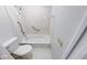 Bathroom showcasing a white tile shower/tub, grab bars, toilet, and modern fixtures at 5525 Roxbury Ter, Indianapolis, IN 46226