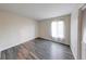 Neutral bedroom featuring hard surface floors and a window with sheer curtains at 5525 Roxbury Ter, Indianapolis, IN 46226