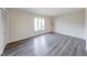 Bedroom with large window, wood-look flooring, and neutral color palette, offering lots of light at 5525 Roxbury Ter, Indianapolis, IN 46226