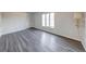 Bright bedroom featuring a large window, plank flooring, and neutral wall color at 5525 Roxbury Ter, Indianapolis, IN 46226