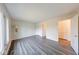 Corner bedroom featuring plank flooring, a large window, and neutral walls, full of light at 5525 Roxbury Ter, Indianapolis, IN 46226