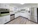 Beautiful kitchen with white cabinets, stainless steel appliances, and new floors at 5525 Roxbury Ter, Indianapolis, IN 46226