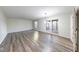 Large, bright living room featuring modern flooring and sliding glass doors at 5525 Roxbury Ter, Indianapolis, IN 46226