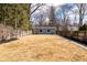 Spacious backyard featuring a detached garage and wood fence, perfect for outdoor activities at 5537 Broadway St, Indianapolis, IN 46220