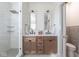 Bright bathroom with a glass shower, double vanity and toilet in a separate room at 5537 Broadway St, Indianapolis, IN 46220