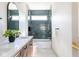 Modern bathroom with stylish blue tile, a soaking tub, and a sleek vanity at 5537 Broadway St, Indianapolis, IN 46220
