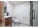 Modern bathroom features a wooden vanity, white marble floors, and a walk-in shower at 5537 Broadway St, Indianapolis, IN 46220