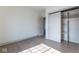 Bedroom featuring hardwood floors, light walls, and a closet with sliding doors at 5537 Broadway St, Indianapolis, IN 46220