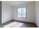 Bright bedroom with hardwood floors and a large window offering natural light at 5537 Broadway St, Indianapolis, IN 46220