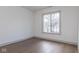 Bedroom featuring hardwood floors and a large window overlooking the exterior at 5537 Broadway St, Indianapolis, IN 46220